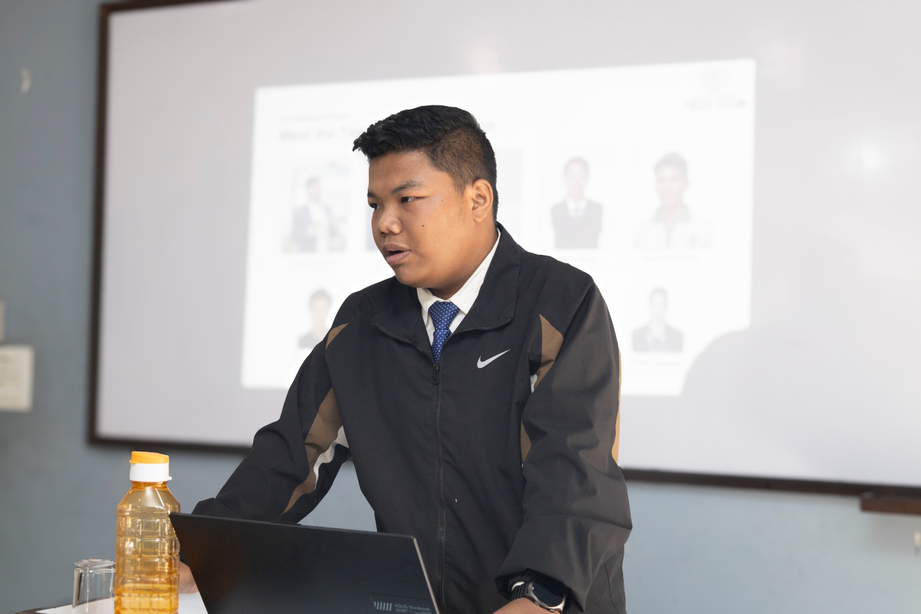 Close-up of Sugam Ghale presenting a slide of the SCM Tech Club team