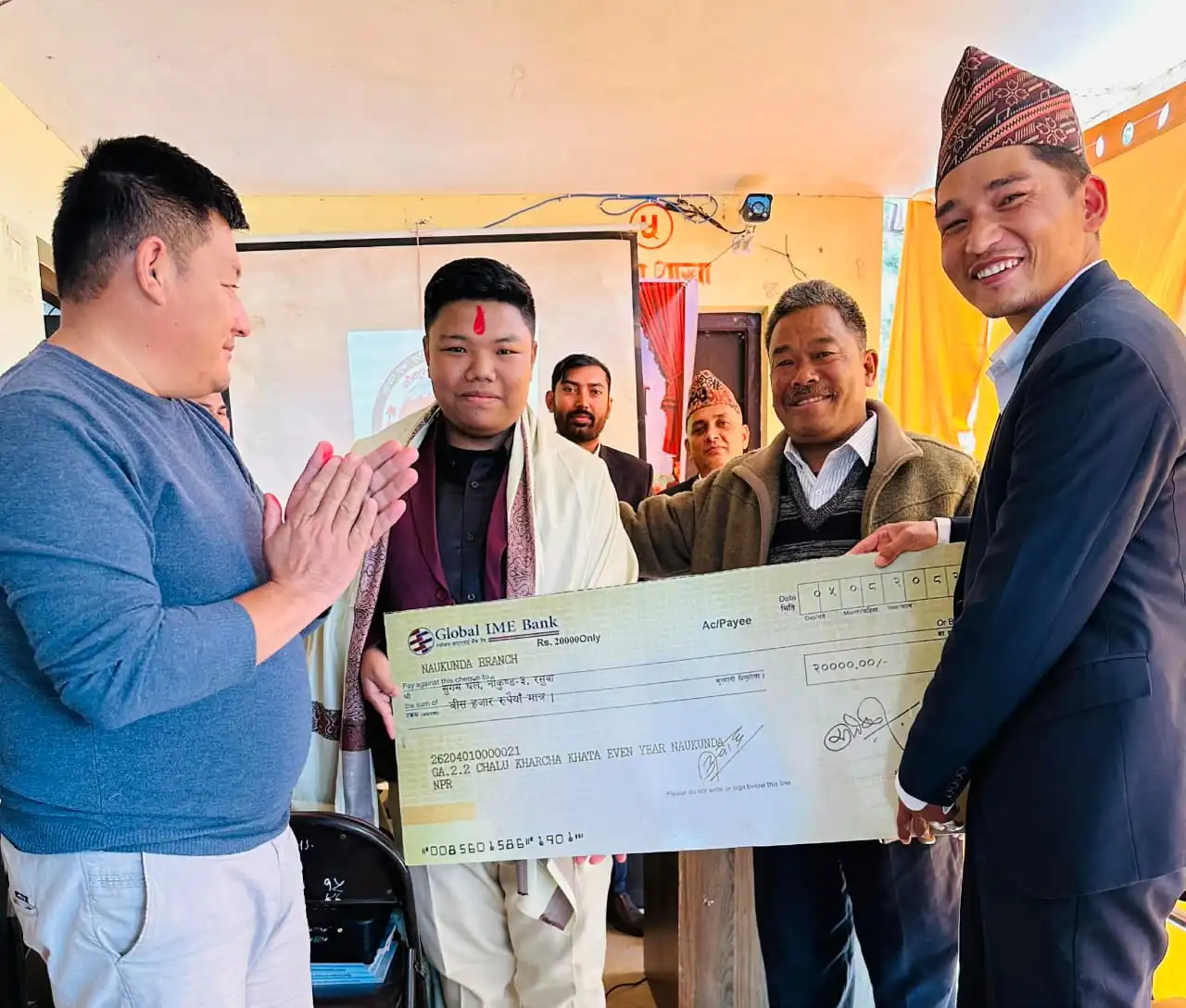 Sugam Ghale receiving the NPR 20,000 prize cheque at Naukunda Rural Municipality