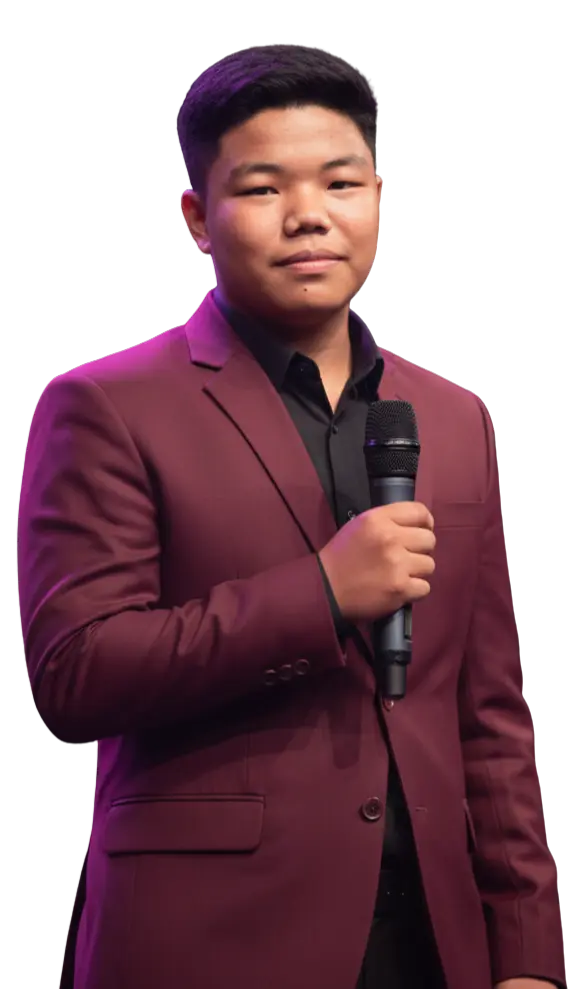 Sugam Ghale holding a microphone, wearing a maroon blazer