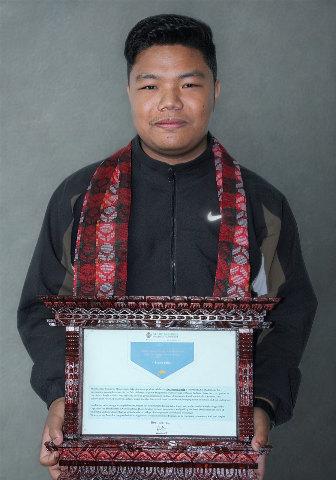 Sugam Ghale holding the framed certificate from Shubhashree College of Management