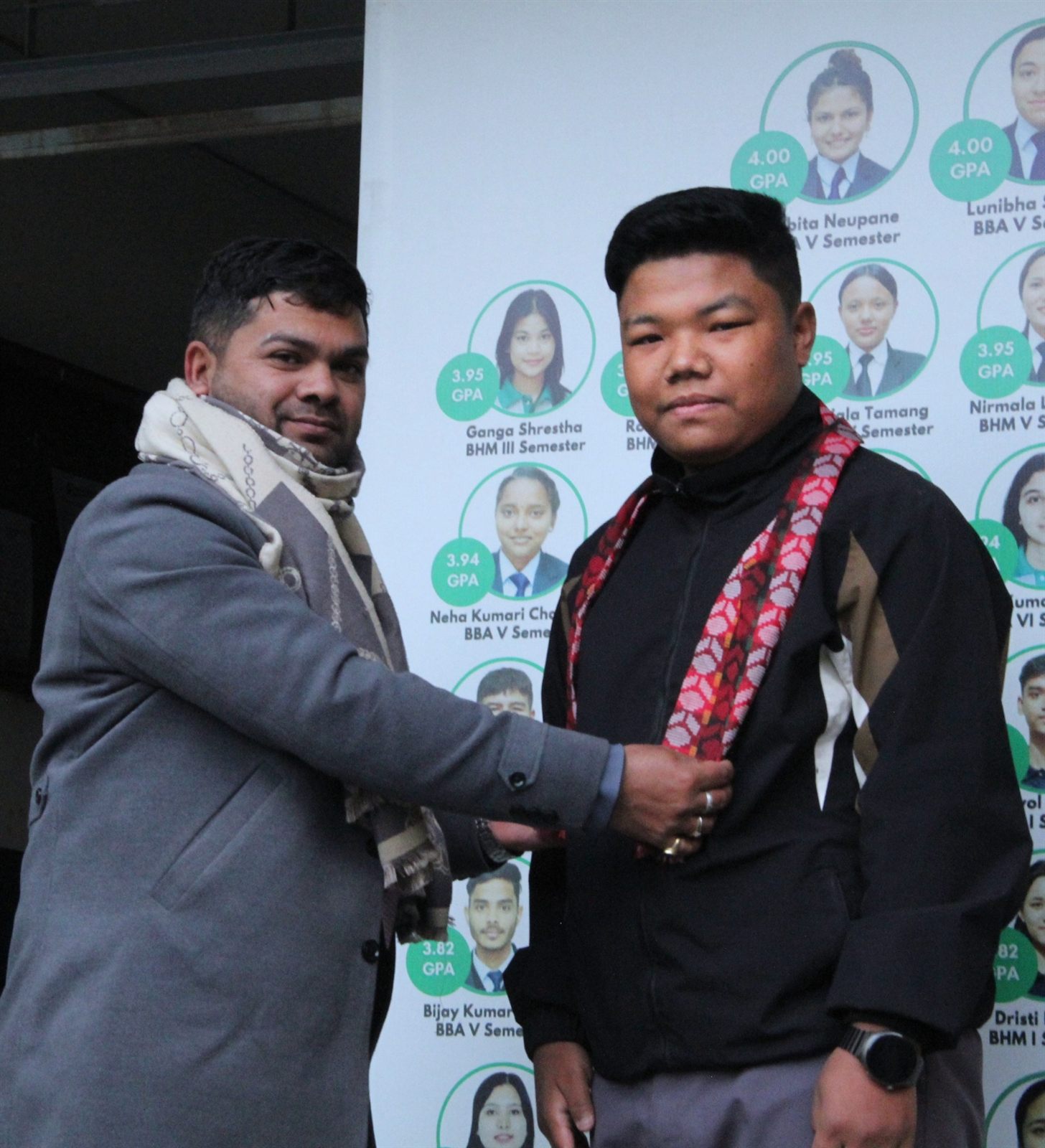 Jayaraj Sir placing a red patterned scarf during the ceremony